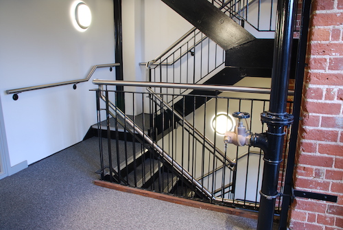 vintage staircase on a antique residential building with brick wall stones as a strong architectural detail