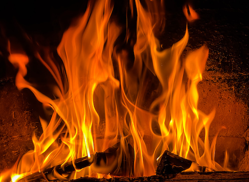 Flames of fire on a black background. Burning wood in the fireplace